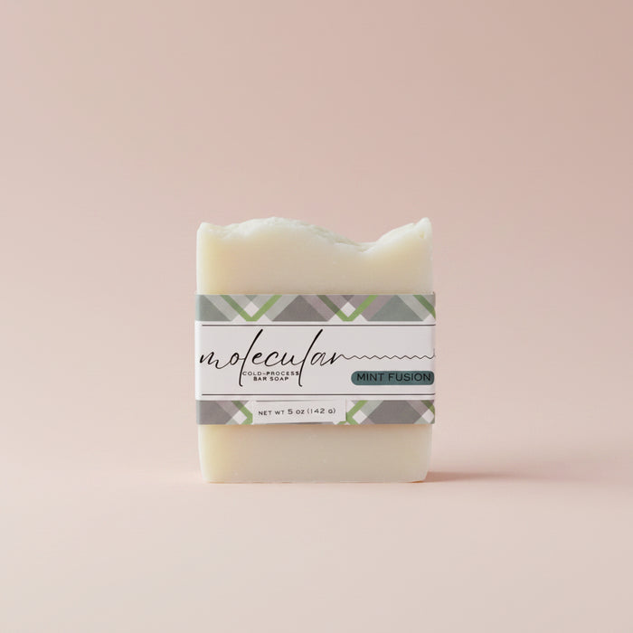 Rough white bar soap with a green plaid label.