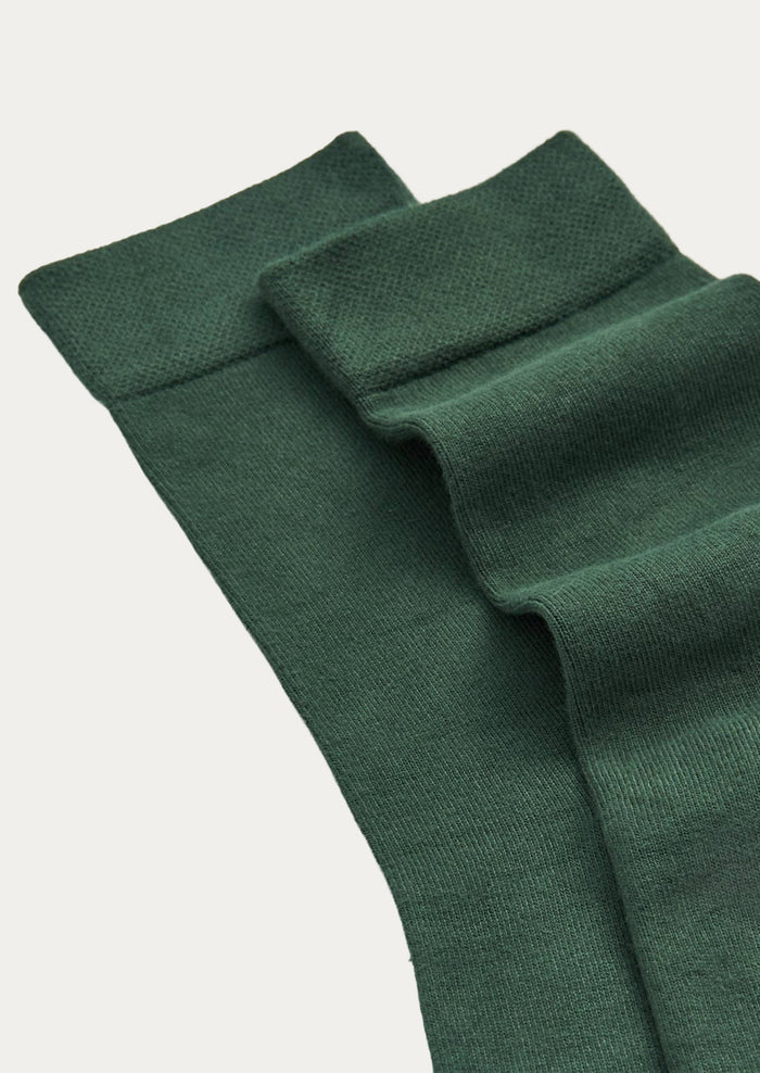 A pair of forest green bamboo blend calf-length crew socks.