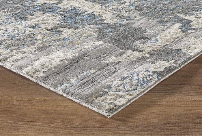 Runner with a layered design featuring medium grey, deep charcoal, blue, and cream colors, and textured patterns.