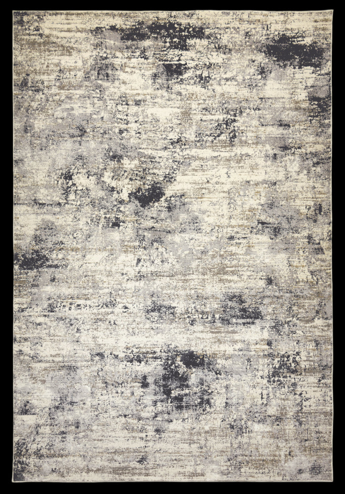 A modern abstract area rug with light grey and deep charcoal splatters on a cream/taupe background.