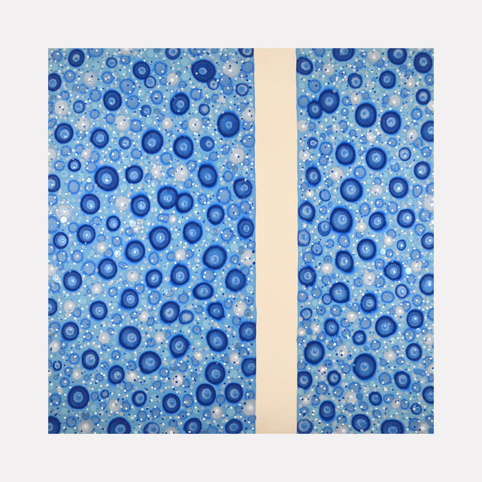 The artwork 'Implicate Order' by Eric Jiaju Lee features a mesmerizing pattern of circular blue forms scattered across a light blue background, divided by a vertical cream-colored strip. The circles appear as concentric rings in varying shades of navy and cerulean blue, creating a cellular or bubble-like effect. The organic, flowing pattern suggests movement and depth on the acrylic canvas surface.